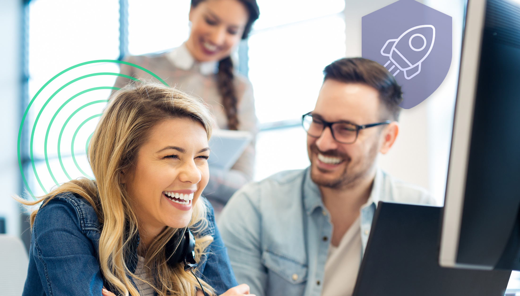 Female and male colleagues smiling and enjoying working on the computer