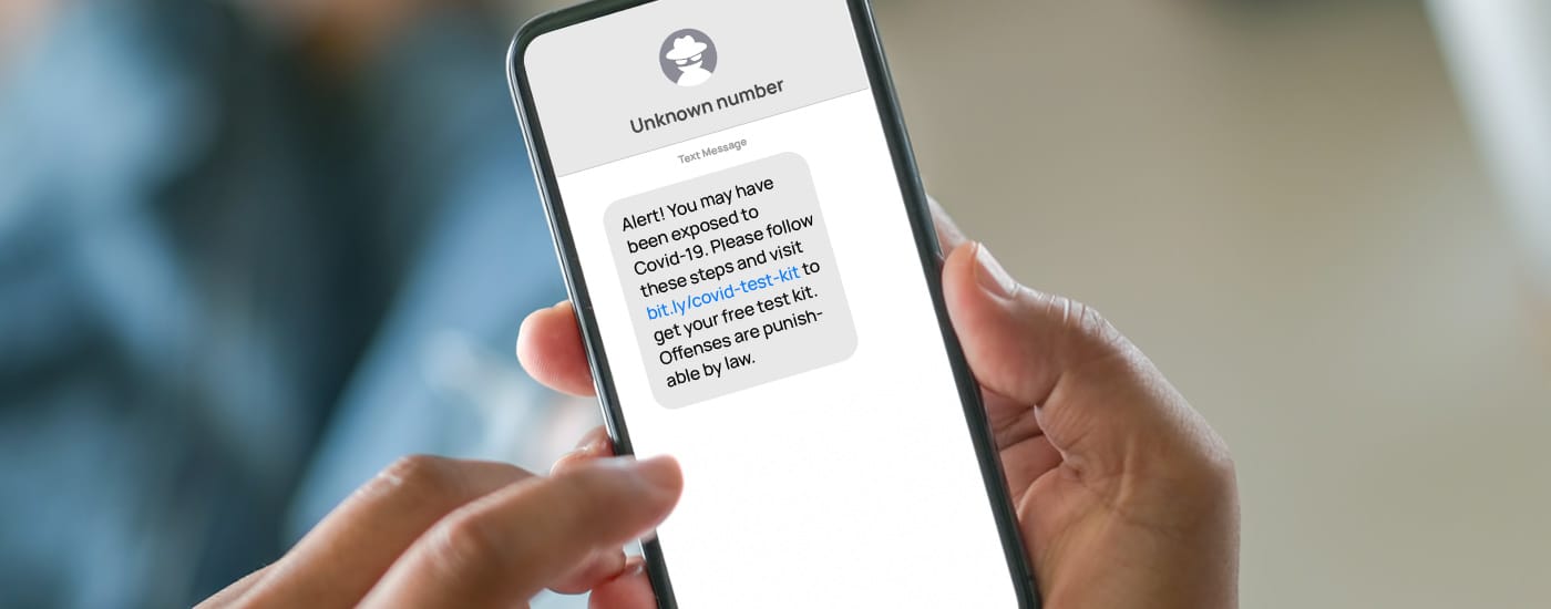 Phone screen showing a smishing attack claiming that the victim has been exposed to Covid-19.