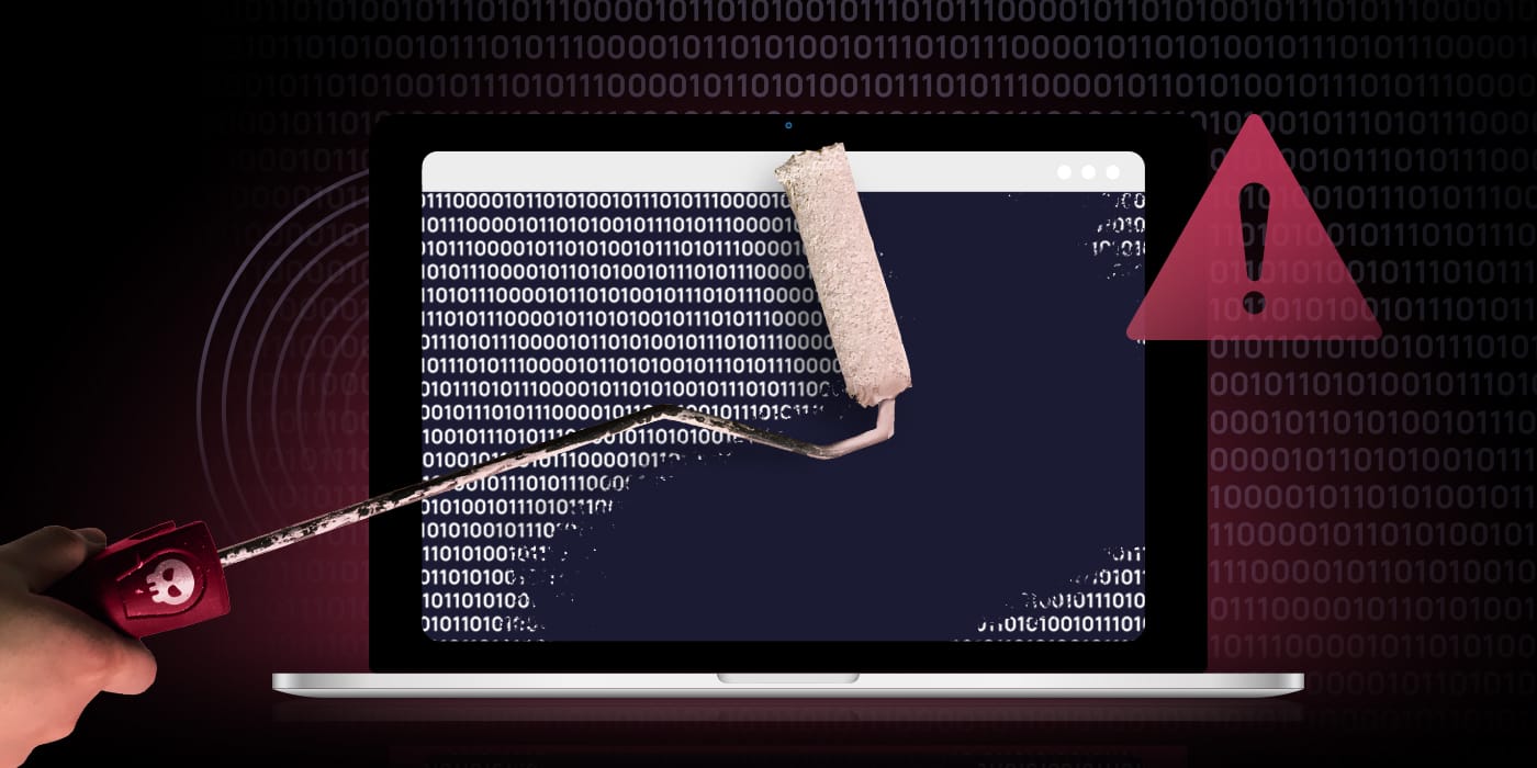 A hacker using a paint roller to wipe out data from a laptop screen