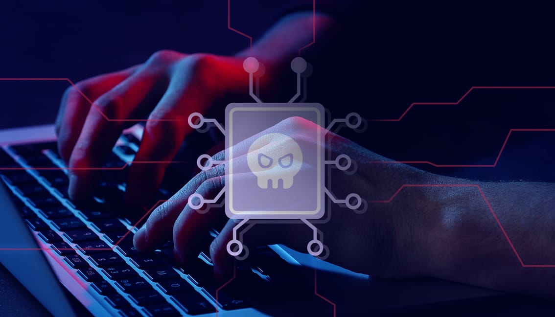 An icon symbolizing malware positioned in front of a detailed close-up of a person's hands engaged in writing on a laptop keyboard